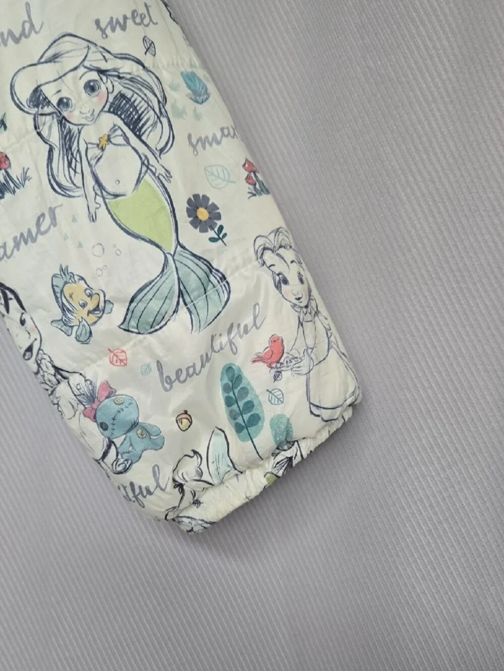 Disney Quilted Puffer Jacket with Cream Background and Pastel Accents